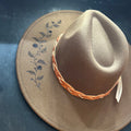 Organic, flowing vine design hand-burned into the felt of a custom wide-brim hat. Winding ivy and botanical silhouettes etched with a pyrography pen.